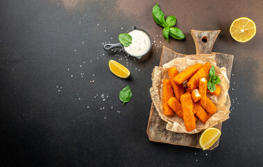 Crumbed golden fried fish fingers in sticks with tartare sauce. banner, menu, recipe place for...
