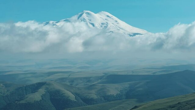 View of Elbrus from the Bermamyt plateau. Caucasus 2023. A trip to Bermamyt, the Grand Canyon in Russia. Mountain landscape on a summer day. Blue sky of Karachay-Cherkessia. Caucasian Ridge 4K