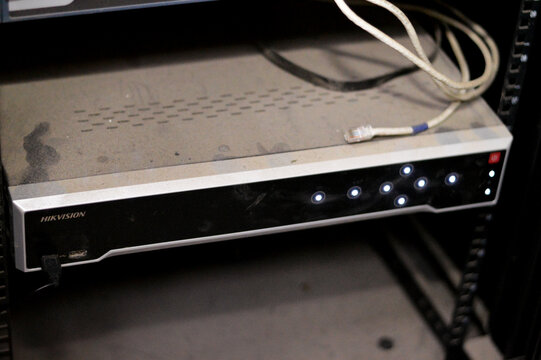 Cairo, Egypt, October 3 2023: HikVision NVR device and network switch, network video recorder (NVR) is a specialized computer system that includes a software that records video on a storage device