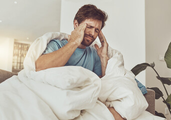 Stress, headache and sick man on a sofa with burnout, vertigo or pain from insomnia at home....