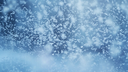 Beautiful background image of light snowfall falling over of snowdrifts