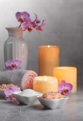 Obraz na płótnie Canvas Sea salt, towels, orchid flowers, and burning candles.