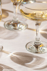 A glass with sparkling wine on the table, wine tasting, party and celebration concept, illuminating
