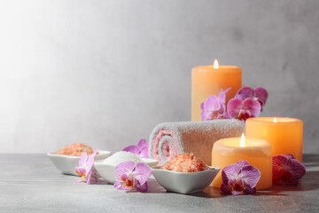 Sea salt, towels, orchid flowers, and burning candles.