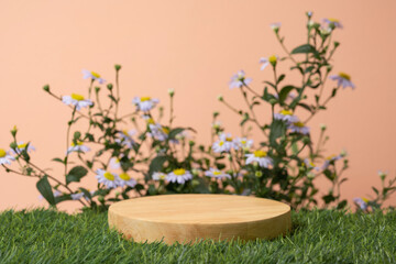 Wood podium table top on green grass blurred flower tropical forest plant nature background.Natural product placement pedestal stand display,floral blossom spring concept.