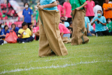 Students play running sack during sports day at school.Outdoor sports is good for children.