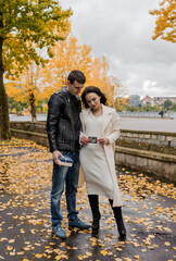 A man hugs his pregnant wife. Woman holding ultrasound photo of baby
