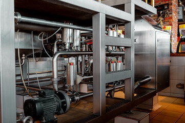 Fototapeta premium Modern brewery pump and pipelines. Brewery `close-up backgrounds.
