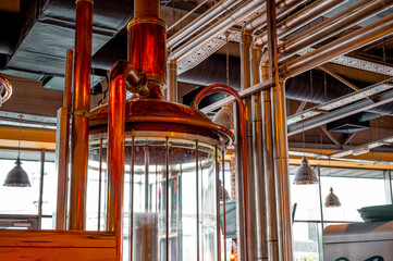 Modern brewery mash tuns. Glass tuns. Copper elements for brewing Boiling and mashing tun. Brewery `close-up backgrounds.