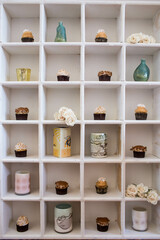 Cupcakes and vases on a vintage shelf