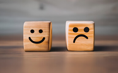 Smile face and sad face on wooden block cube for positive mindset concept