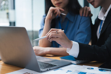 Group Of two Businesswomen Collaborating In Creative Meeting Around Table In Modern Office