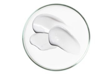 Petri dish isolated on empty background. A smear of cosmetic cream in a Petri dish.