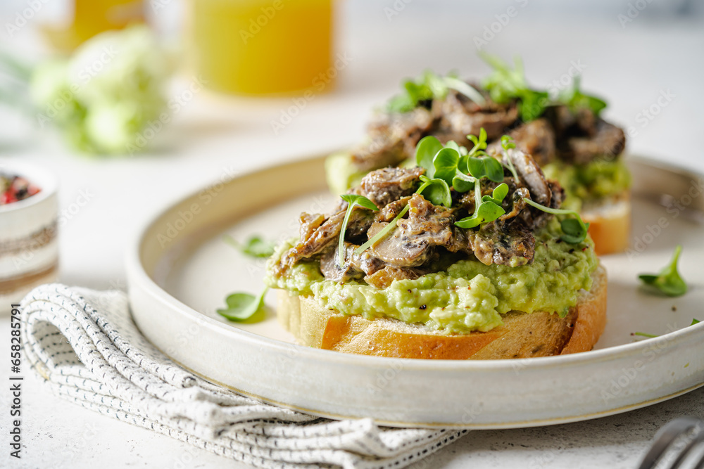 Wall mural Toast avocado, mushrooms and microgreens whole grain sandwich. Vegetarian food. Vegan menu. Delicious breakfast or snack, Clean eating, dieting, vegan food concept.