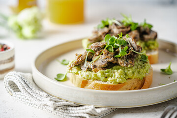 Toast avocado, mushrooms and microgreens whole grain sandwich. Vegetarian food. Vegan menu....