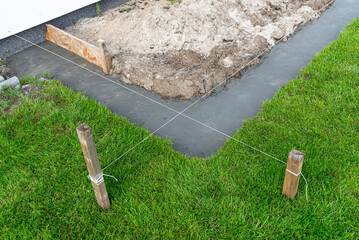 Foundation footings poured in a ditch in the yard, building a terrace in the backyard.
