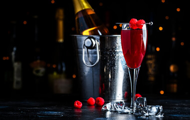 Moulin rouge cocktail drink with calvados, sparkling wine, lychee and raspberry peach puree and...