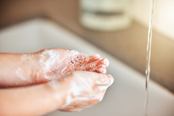 Soap, washing hands and kid by sink for cleaning, hygiene and wellness in bathroom at home. Health,...