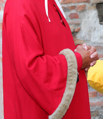 regal elegant red dress with soft fur inserts and hands of man