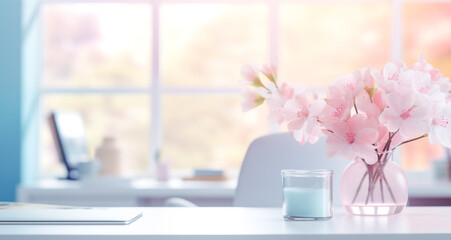 Close up view of simple workspace with laptop, vase with flowers on white table with blurred office room background © Viks_jin