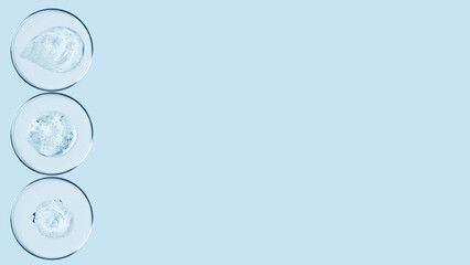 Petri dishes and drops and ointments of transparent gel or serum on a blue background. Banner with empty space for advertising.