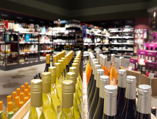 defocused alcohol (wine, champagne, liquor, whiskey) on store shelves