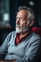 Obraz premium older man sitting in an armchair with all his memories