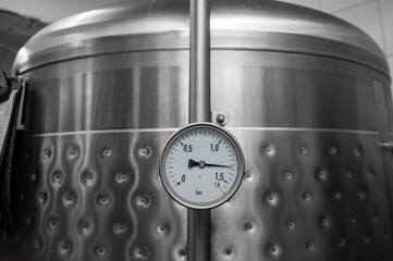 Pressure gauge on the pipe of craft brewing equipment in a brewery - obrazy, fototapety, plakaty