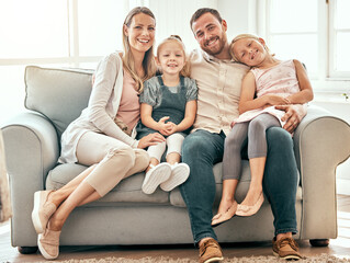 Smile, love and portrait of family on a sofa in the living room bonding and relaxing together at...