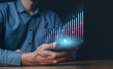 stock, bar, chart, diagram, finance, graph, growth, market, economy, financial. close up to hand hold smart phone, above their chart of investment and diagram is direct variation slowly growth up.