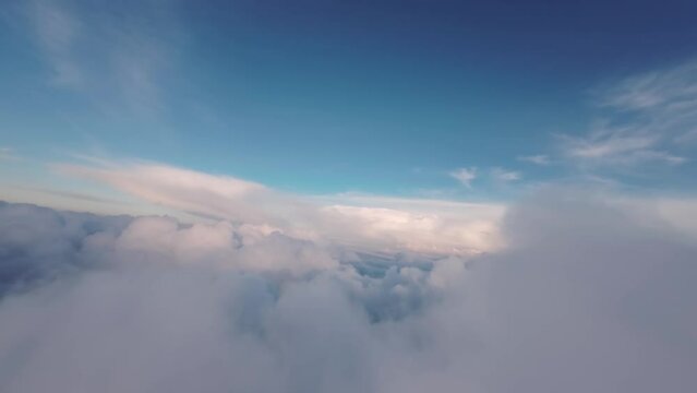 A unique view from the cockpit of a jet flying into cumulonimbus clouds at sunset. fpv fixed wing view. real flight in real clouds