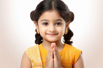 Cute indian little girl child making namaste or praying gesture - obrazy, fototapety, plakaty