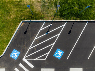 Aerial image looking straight down over two handicap, ADA, parking stalls.
