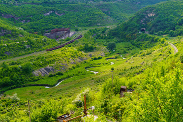 Fototapeta na wymiar Picturesque green hilly valley. Background with selective focus and copy space