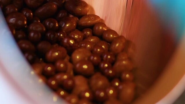 chocolates spinning in a candy machine at a sweets factory