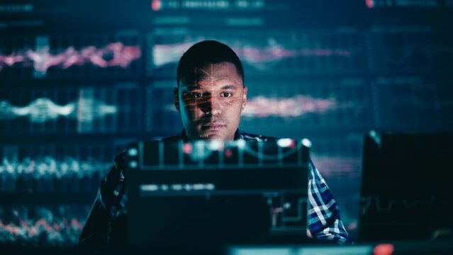 Young man programmer finishes a computer program, futuristic style, success