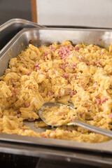 Tray of screambled eggs on a breakfast buffet