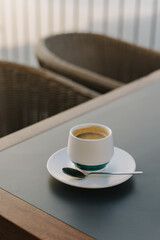 Cup of black coffee on a table in a cafe.