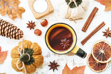 Fall background. Autumn tea, spices, orange leaves, and home decor. Flat lay with copy space.
