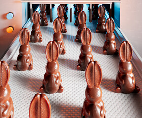 Conveyor belt with chocolate easter bunnies. Production line of sweet dessert