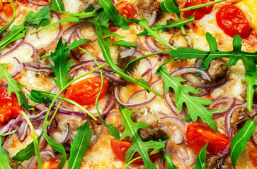 ready-made pizza with meat, onions and herbs, close-up