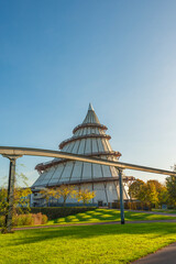 Magdeburg, Germany. Cover page with science and technology exhibition tower as a cone in the Elbauen city park. Cityscape in the historical downtown in Magdeburg at sunny Autumn day, blue sky, sunset