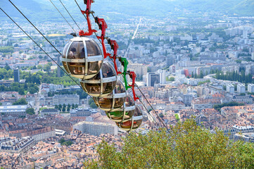 View on central part of Grenoble city from Bastille fortres witn mountains around, old cable car,...