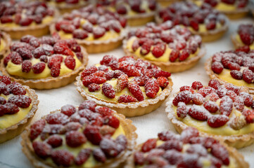 Wild fragolino strawberry and raspberry cakes in ancient city of strawberry Nemi, Castelli Romani, Italy close up