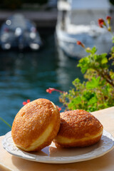 Fried in oil french stuffed with apples or chocolate beignets donuts pastry, sweet dessert served outdoor
