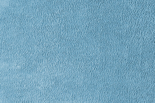 Terry cloth, blue towel texture background. Soft fluffy textile bath or beach towel material. Top view, close up.