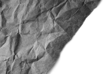 Recycled crumpled black paper texture with diagonal torn edge isolated on transparent, white background, PNG. Wrinkled and creased abstract backdrop, wallpaper with copy space, top view.