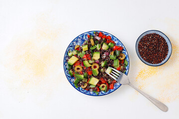 Quinoa salad with olives,avocado,cherry tomatoes,onion,green.