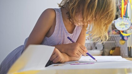 Naklejka premium Young Caucasian Girl Doing Homework for Elementary School
