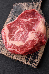 Fresh juicy raw beef striploin steak with salt and spices